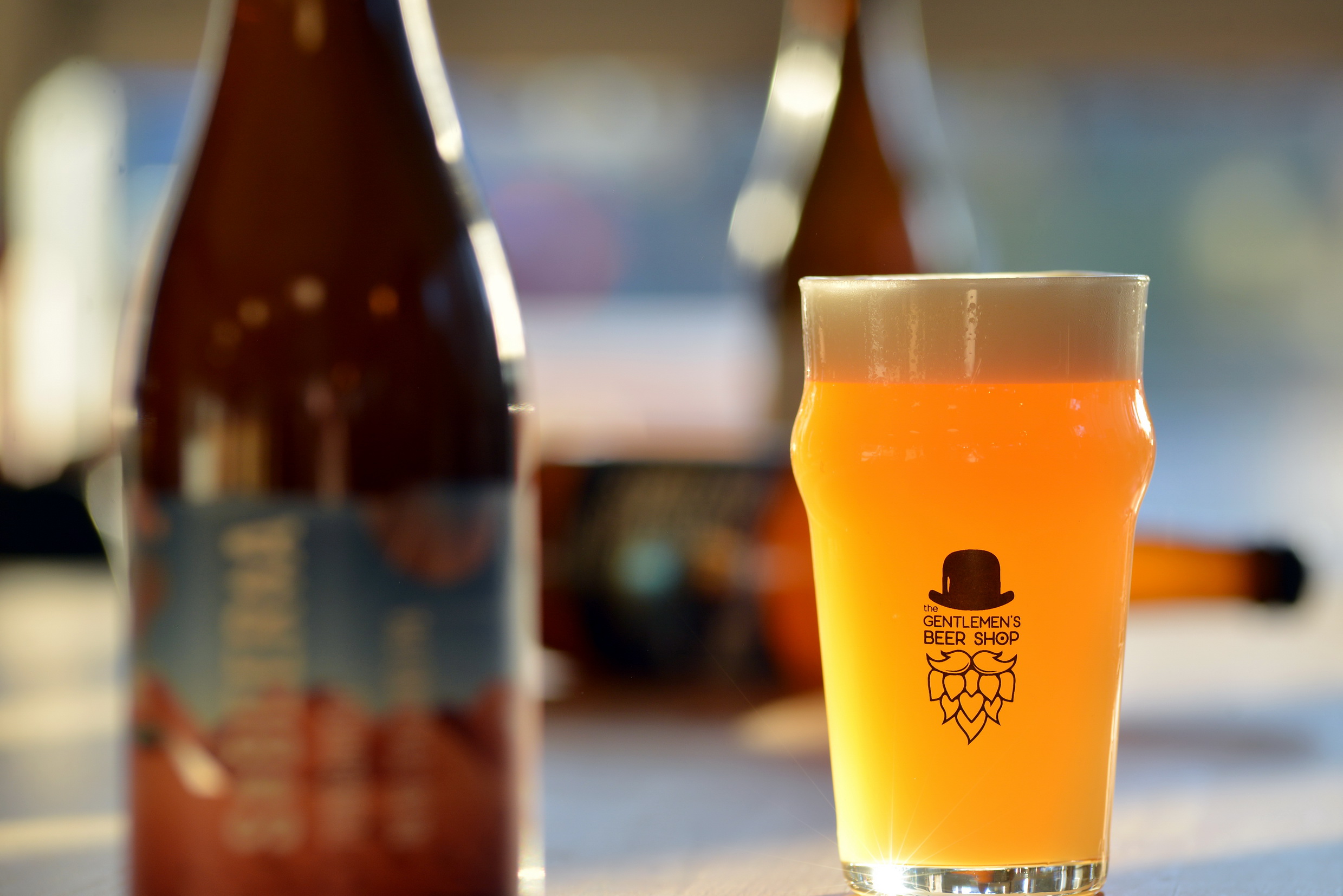 The Gentlemen's Beer Shop branded glass with golden hazy IPA